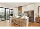 Bright kitchen with stainless steel appliances, white cabinets, and island seating at 527 E North St, Indianapolis, IN 46204
