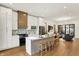 Bright kitchen featuring an island with barstool seating, stainless appliances, and open to living area at 527 E North St, Indianapolis, IN 46204
