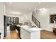 Bright kitchen featuring an eat-in island, stainless appliances and open to the staircase at 527 E North St, Indianapolis, IN 46204