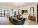 Open-concept living room featuring modern lighting, neutral paint, stylish furniture, and hardwood flooring at 527 E North St, Indianapolis, IN 46204