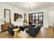 Open-concept living room with modern furniture, hardwood floors, and a large window at 527 E North St, Indianapolis, IN 46204