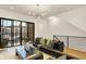 Cozy living room with a stylish couch, area rug, sliding glass doors, and modern lighting at 527 E North St, Indianapolis, IN 46204