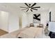 Spacious bedroom with neutral carpet, ceiling fan, and contemporary artwork at 527 E North St, Indianapolis, IN 46204