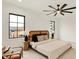 Bright bedroom featuring large windows, stylish fan and minimalist furniture at 527 E North St, Indianapolis, IN 46204