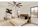 Modern main bedroom featuring neutral tones, a ceiling fan, and views of the neighborhood at 527 E North St, Indianapolis, IN 46204