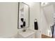 Stylish powder room featuring a modern vanity, mirror, and convenient towel bar at 527 E North St, Indianapolis, IN 46204