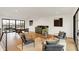 Open-concept sitting area with modern furniture, hardwood floors, wet bar, and a large window at 527 E North St, Indianapolis, IN 46204