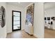 Inviting entryway with front door, modern art, and view to home office at 531 E North St, Indianapolis, IN 46204