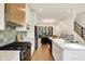 Modern kitchen features stainless appliances, breakfast bar, and flows into the living area at 531 E North St, Indianapolis, IN 46204