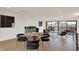 Open concept living area with a dining area, wet bar, hardwood floors and comfortable seating arrangements at 531 E North St, Indianapolis, IN 46204