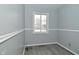 Bedroom with gray walls, vinyl flooring, and a window at 306 W Janet Dr, Brownsburg, IN 46112