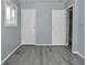 Bedroom with gray walls, vinyl flooring, and two doors at 306 W Janet Dr, Brownsburg, IN 46112