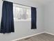Simple bedroom with dark blue curtains and vinyl flooring at 306 W Janet Dr, Brownsburg, IN 46112