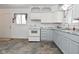 Bright kitchen features white and gray cabinets, and vinyl flooring at 306 W Janet Dr, Brownsburg, IN 46112