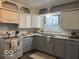Charming kitchen features white and gray cabinets, marbled countertops, and a bright window at 306 W Janet Dr, Brownsburg, IN 46112