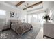 Spacious bedroom with wood beams, ceiling fan, and large windows at 11362 Selsey Rd, Fishers, IN 46040