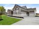 Gray farmhouse exterior with white trim, stone accents, and a large driveway at 11362 Selsey Rd, Fishers, IN 46040