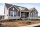 Gray two-story house with white accents and stone facade at 11362 Selsey Rd, Fishers, IN 46040