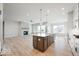 Open concept kitchen with island and hardwood floors at 11362 Selsey Rd, Fishers, IN 46040