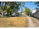 View of backyard with gravel driveway and neighboring houses at 1320 Pearl St, Columbus, IN 47201