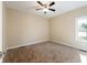 Simple bedroom with carpet, ceiling fan, and window at 1320 Pearl St, Columbus, IN 47201