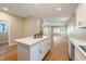 Open concept kitchen with island, white cabinets and hardwood floors at 1320 Pearl St, Columbus, IN 47201