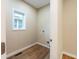 Small laundry room with vinyl flooring and window at 1320 Pearl St, Columbus, IN 47201