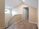 Upstairs hallway with carpet, neutral walls, and access to a bedroom at 1320 Pearl St, Columbus, IN 47201