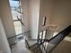 Elegant staircase with modern metal railing and two statement light fixtures at 10876 Holliday Farms Blvd, Zionsville, IN 46077