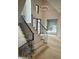 Modern staircase with black metal railing and light hardwood floors at 10876 Holliday Farms Blvd, Zionsville, IN 46077