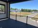 A covered balcony with black decking, providing views of the green space and local area at 379 S Cherry St, Westfield, IN 46074