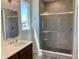 Modern bathroom with tiled walk-in shower, glass door, sleek fixtures, and a bright window at 379 S Cherry St, Westfield, IN 46074