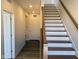 Inviting entryway featuring hardwood floors, staircase with wooden handrail, and neutral wall color at 379 S Cherry St, Westfield, IN 46074