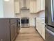 Modern kitchen with stainless steel appliances, white subway tile backsplash, and custom cabinetry at 379 S Cherry St, Westfield, IN 46074