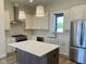 Elegant kitchen featuring white cabinetry, stainless steel appliances, and a center island with stone countertop at 379 S Cherry St, Westfield, IN 46074