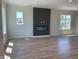 Open-concept living area featuring a modern fireplace, hardwood floors, and neutral paint at 379 S Cherry St, Westfield, IN 46074