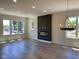Spacious living room featuring a modern fireplace, hardwood floors, recessed lighting, and large windows at 379 S Cherry St, Westfield, IN 46074