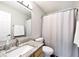 Modern bathroom with granite vanity top, white cabinets, shower with curtain, and a large well-lit mirror at 19140 Golden Meadow Way, Noblesville, IN 46060