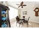 Cozy dining area with wood floors, a chandelier, and a ceiling fan offer a comforting place to dine at 19140 Golden Meadow Way, Noblesville, IN 46060