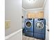 Laundry room with cabinets and front-loading washer and dryer at 19140 Golden Meadow Way, Noblesville, IN 46060