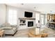 Bright living room featuring a fireplace, mantle with built-ins, and luxury vinyl plank flooring at 19140 Golden Meadow Way, Noblesville, IN 46060