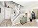 Entryway with staircase, white railing, and decorative shelf adds character to the home at 19140 Golden Meadow Way, Noblesville, IN 46060