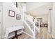 Elegant staircase with white railing, carpeted steps, and wall decor adds charm to the entryway at 19140 Golden Meadow Way, Noblesville, IN 46060