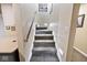 Carpeted staircase with wood railing and recessed lighting leads to the upper level of the home at 19140 Golden Meadow Way, Noblesville, IN 46060