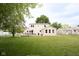 Large fenced backyard with deck, table and grill with green grass and beige siding at 605 Brentwood E Dr, Plainfield, IN 46168