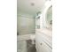 Serene bathroom with soft green walls, a decorative mirror, and a shower-tub combo at 605 Brentwood E Dr, Plainfield, IN 46168