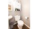 Cozy bathroom with grey walls, white cabinets, modern toilet, and dark wood-look flooring at 605 Brentwood E Dr, Plainfield, IN 46168