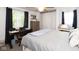 Bedroom featuring large bed, two curtained windows, and desk setup at 605 Brentwood E Dr, Plainfield, IN 46168