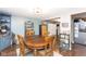 Cozy dining room features a round wooden table, adjacent to the kitchen and a display case at 605 Brentwood E Dr, Plainfield, IN 46168