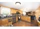 Open kitchen featuring wooden cabinetry and stainless steel appliances that flows into the living space at 605 Brentwood E Dr, Plainfield, IN 46168